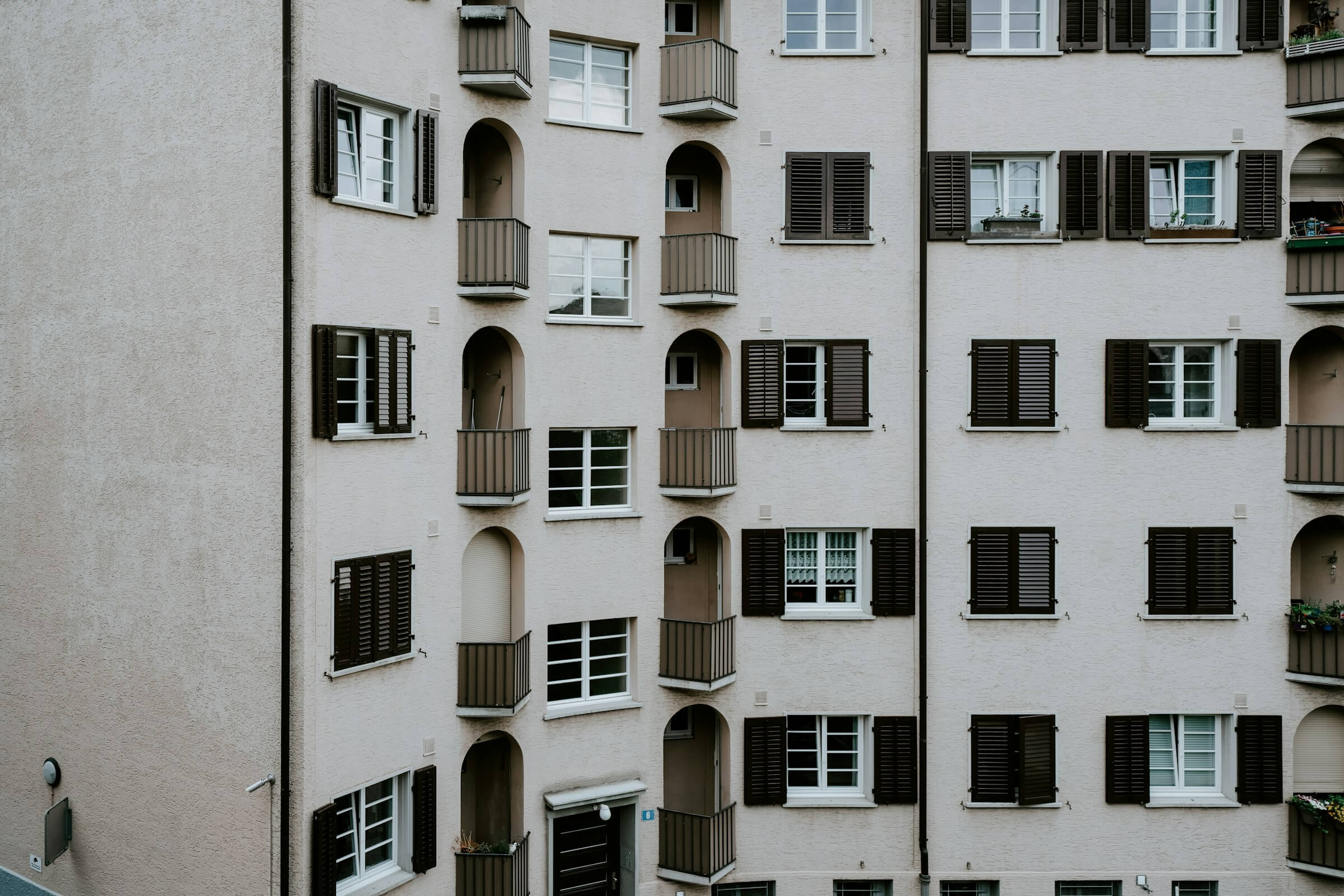 Exterior of apartment building with balconies and windows, symbolizing tenant living and rental housing. Read the US Prime Realty Tenant's Guide for more information.