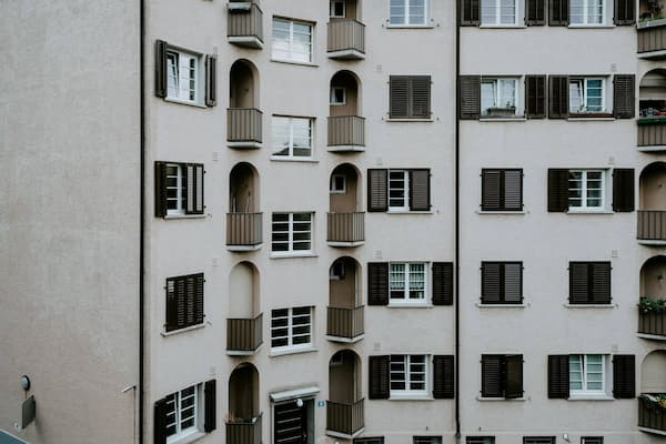 Exterior of apartment building with balconies and windows, symbolizing tenant living and rental housing. Read the U.S. Prime Realty Tenant's Guide for more information.