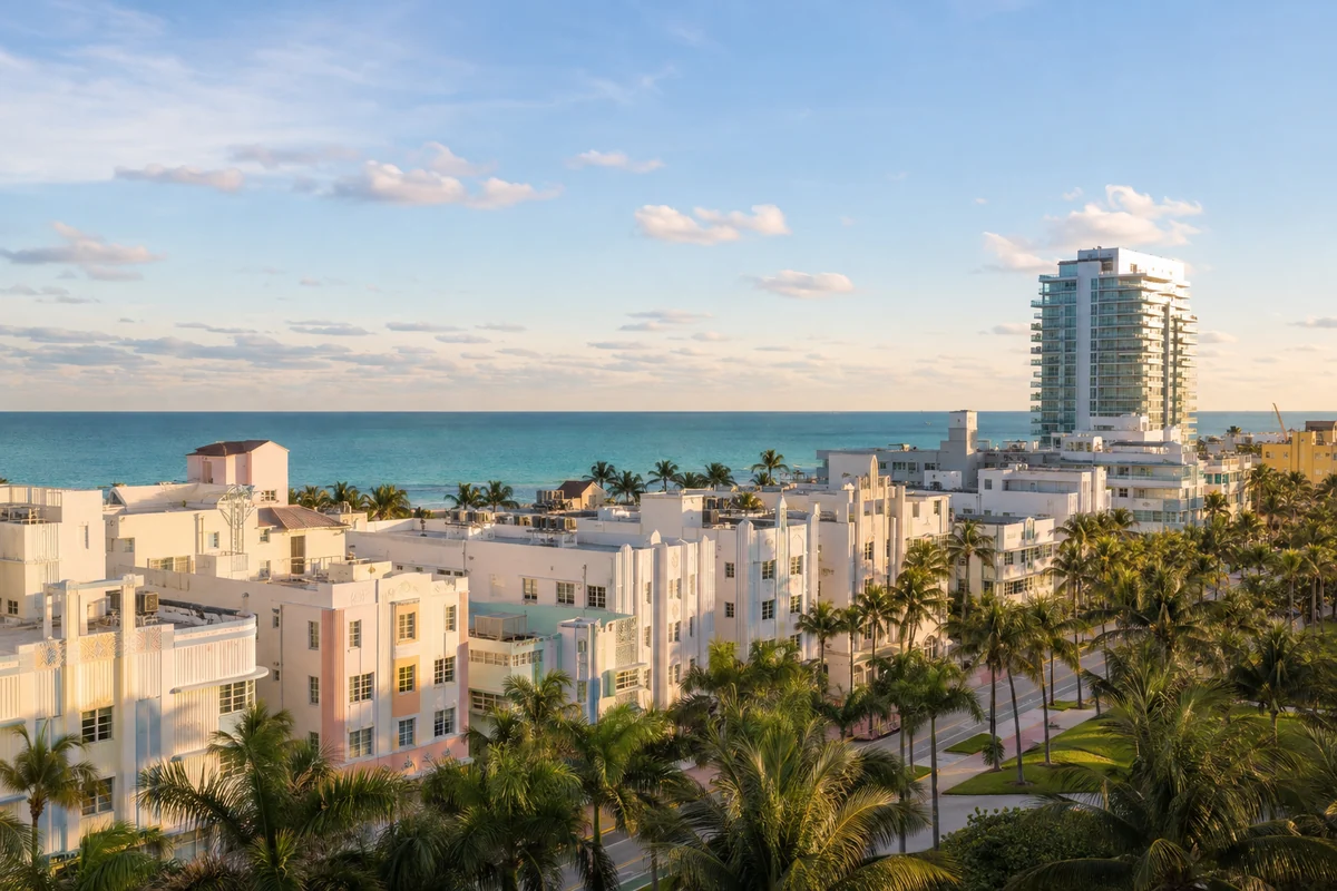 South Beach Apartments: Prices, Costs, and How to Buy in 2026 5 Pastel Art Deco apartment buildings along Ocean Drive in South Beach Miami with a modern white condo tower and the Atlantic Ocean behind